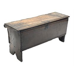 17th century boarded oak plank coffer, hinged lid with chip-carved edges and moulded decoration over matching front, shaped end supports, iron lock