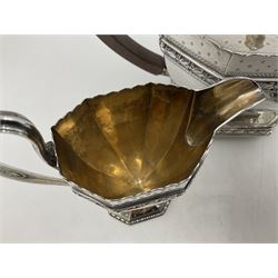 Victorian silver four piece tea service, comprising teapot, teapot stand, twin handled open sucrier and milk jug, each of octagonal form with foliate bud border and engraved decoration including crest to canted panels, and vacant panels, the teapot with ivory finial to the hinged cover and later wooden handle, hallmarked Edward Barnard & Sons Ltd, London1896, teapot including finial H15cm, milk jug including handle H16cm, teapot stand W11.5cm

This item has been registered for sale under Section 10 of the APHA Ivory Act