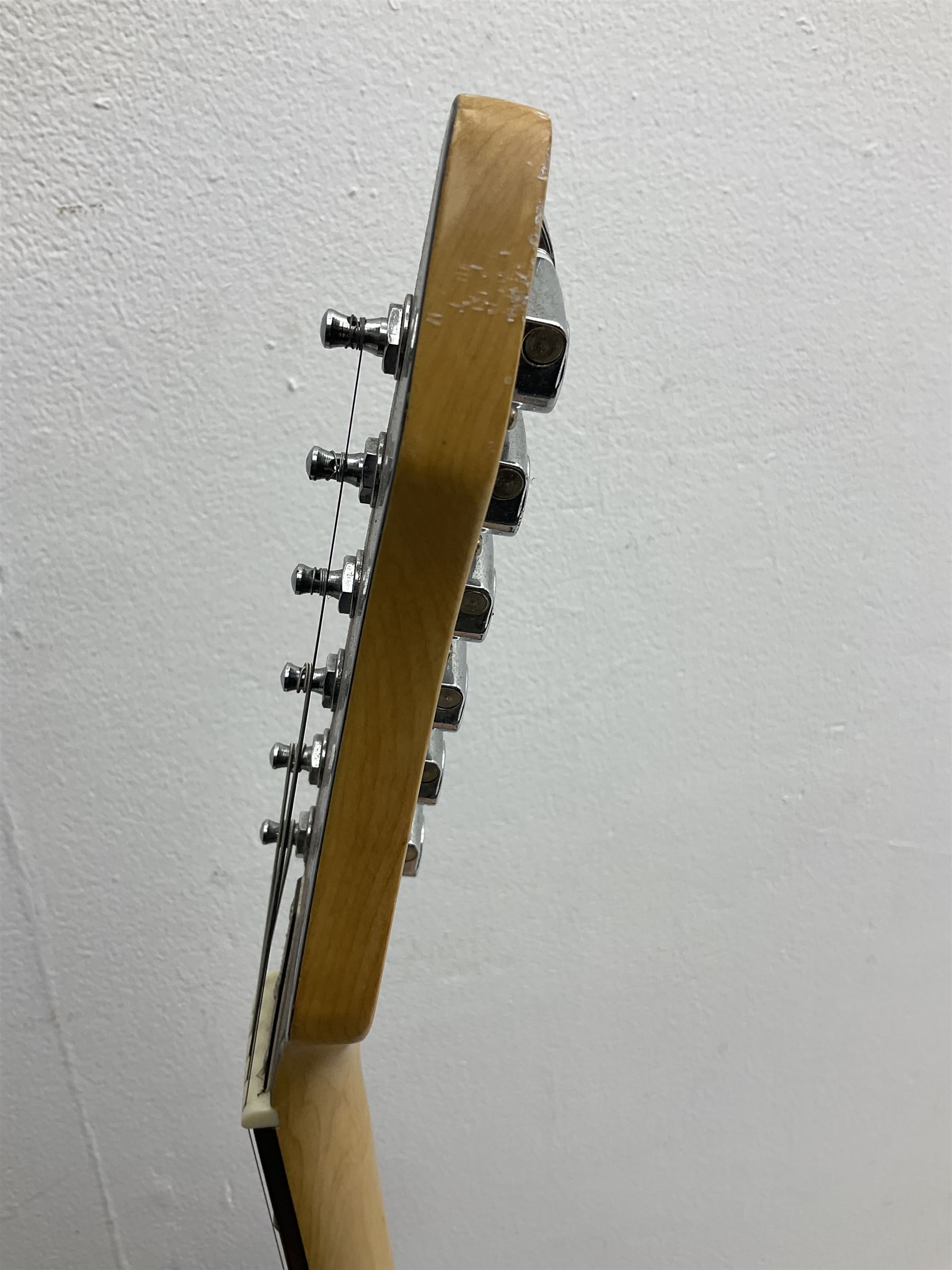 Stagg heavy metal style six-string electric guitar, finished in black with chrome tuning pegs, fret markers and humbucker pickups to bridge L106cm; and Hondo USA electric guitar with black body, ivory coloured pickguard and mother-of-pearl fretmarkers L101cm (2)   