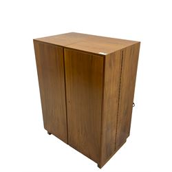 Mid-20th century walnut 'Magic Box' design metamorphic desk cabinet, two doors open to reveal sliding desk with drop leaves, document divisions and internal lamp, on sledge supports 