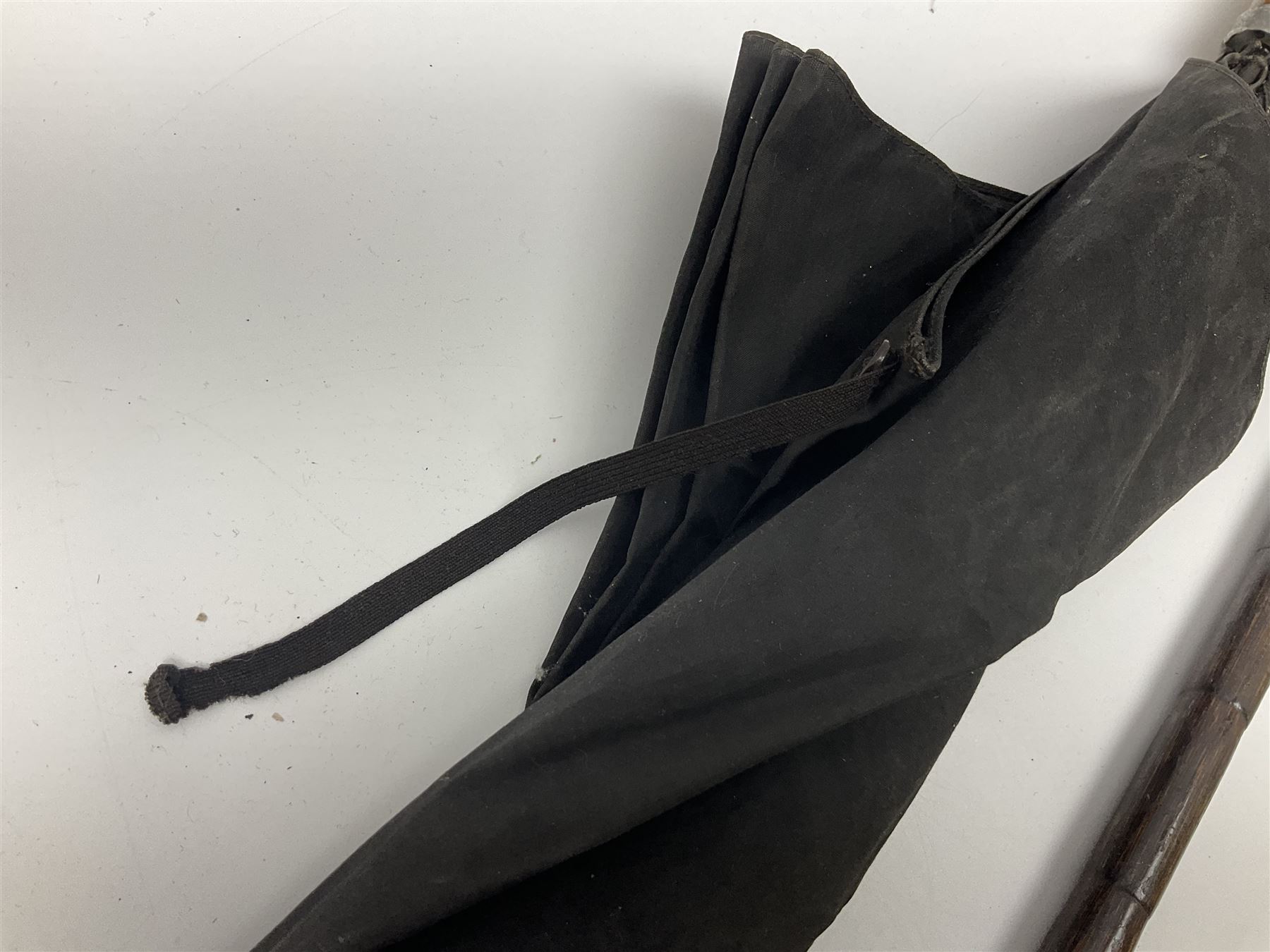 Early 20th century curved horn handle walking stick with hallmarked silver mounts, engraved L Russell 1918, together with a shooting stick by William Mills Birmingham, with leather handle, 'The Featherwaite' shooting stick and an umbrella with wooden handle