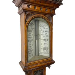 J Hicks - Hatton Garden London, - late 19th century carved oak cased Fitzroy barometer in a richly carved case with a carved crested pediment and square cistern cover, inverted opaline register reflecting FitzRoy's predictions and a scale from 27 to 31 inches of barometric pressure, with a thick bore cistern tube and adjustable rack and pinion twin vernier, fitted with a glazed snail bulb mercury thermometer recording the air temperature in both Fahrenheit and Celsius. Mercury clean and present.
James Joseph Hicks was born in Ireland, however, early in his life he moved to London where he was apprenticed to the instrument maker Louis P Casella. In 1860 he went into business in his own right as a scientific instrument maker at 8 Hatton Gardens. In 1864 he was granted membership to the British Meteorological Society and exhibited instruments at the Royal Society Exhibitions between 1876 and 1913. Hicks was one of London's most prolific and eminent barometer makers. 