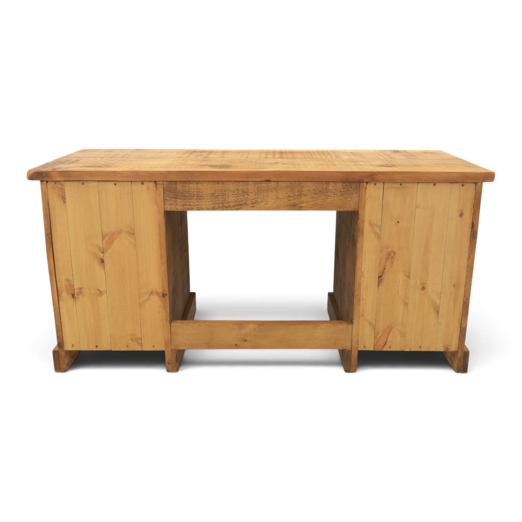 Indigo Furniture - rustic oak twin pedestal desk, rectangular plank top, with central frieze drawer, the fixed pedestals with three drawers and metal cup handles, raised on a plinth base
