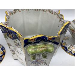 Two French faience polychrome vases and twin handled planter, all decorated with yellow baskets of flowers hanging from ribbons and further blue and orange scrolling foliate designs, tallest H28.5cm, all with painted marks beneath