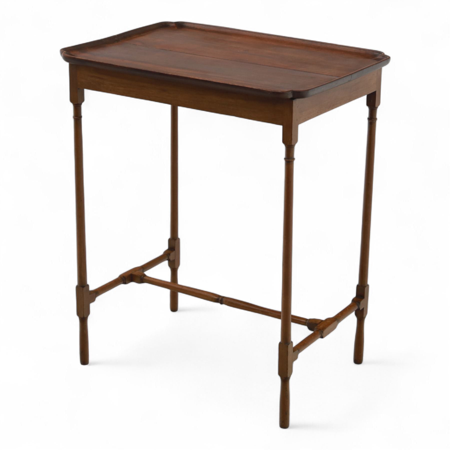 Early 20th century mahogany butler’s tray table, rectangular dished top with shaped corners, raised on turned faux bamboo legs with stretchers