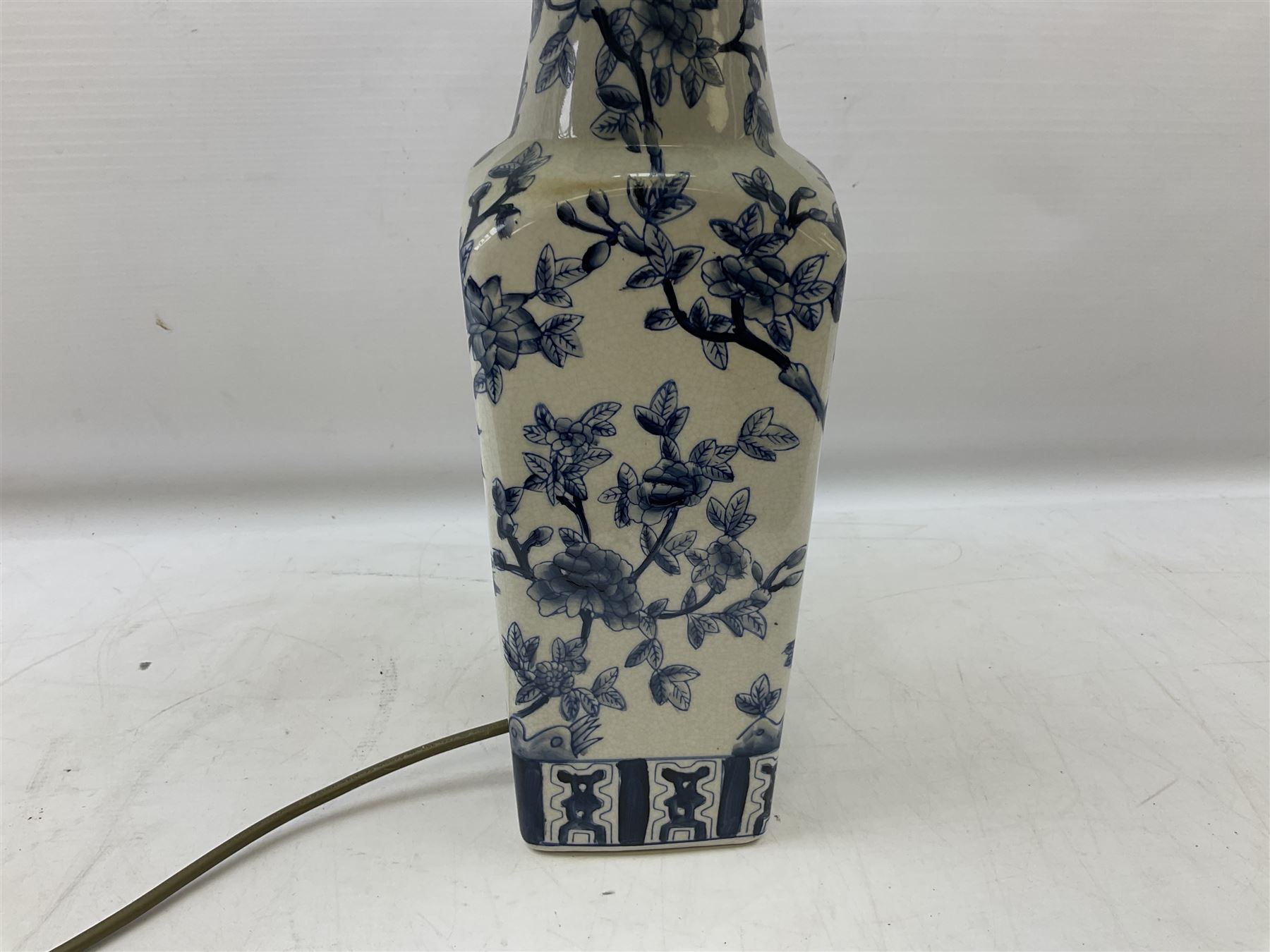 India Jane table lamp, decorated with blue birds and floral vines upon a white ground, fitted with a cream lampshade, H62cm 