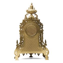 19th century design mantel clock, the brass dial with porcelain numerals, bell strike in brass case of rococo design with urn finial H60cm