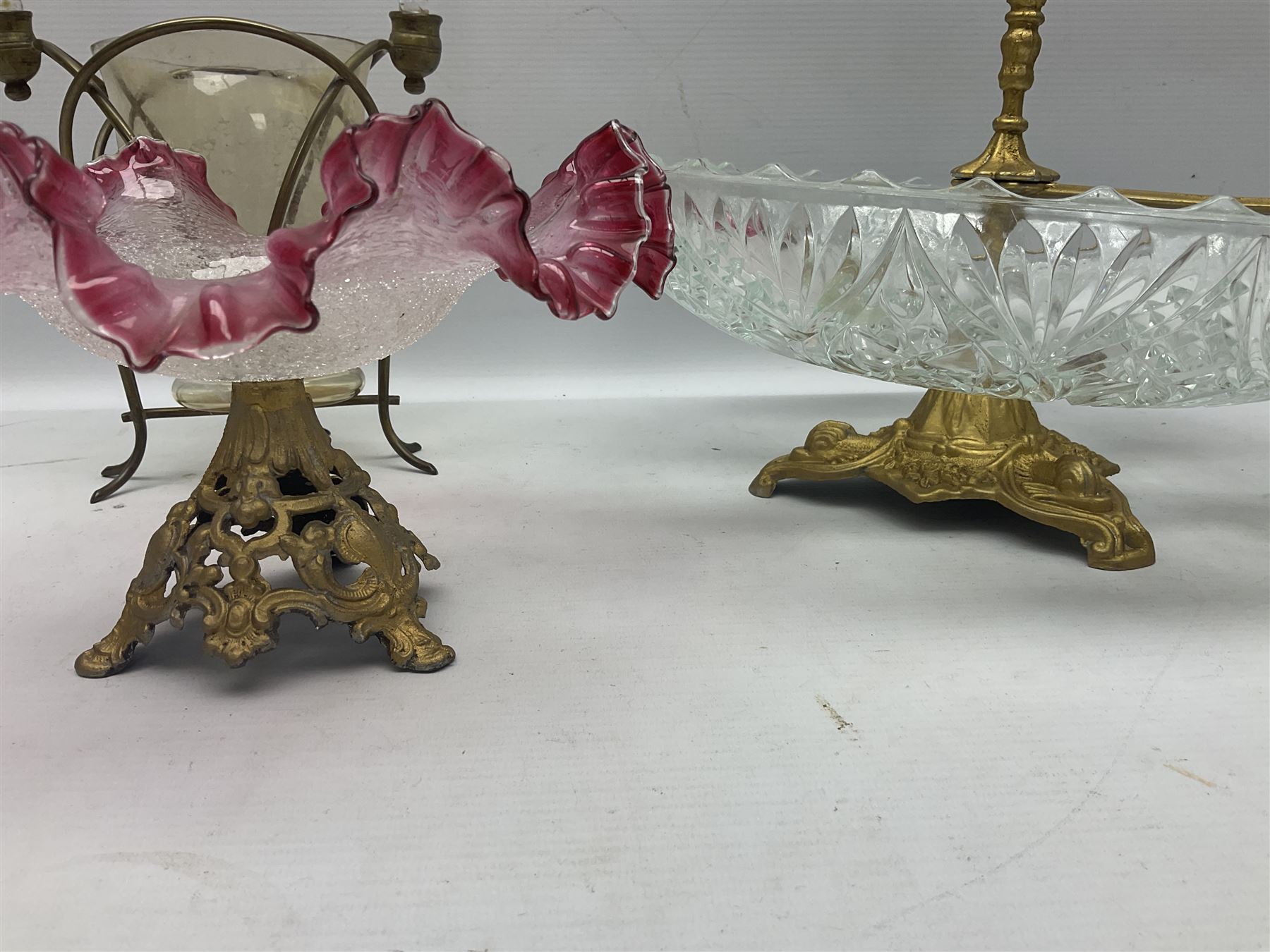 20th century moulded glass and gilt centre piece bowl with carrying handle and ornate trefoil base, together with frilled cranberry edge glass comport with ornate gilt base, and further centre piece with  large glass handle of twisted form, tallest H54cm