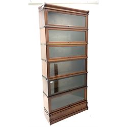 Early 20th Century mahogany Globe Wernicke style seven graduated height stacking book case, with shaped cornice and plinth base, possibly by Gunn of America