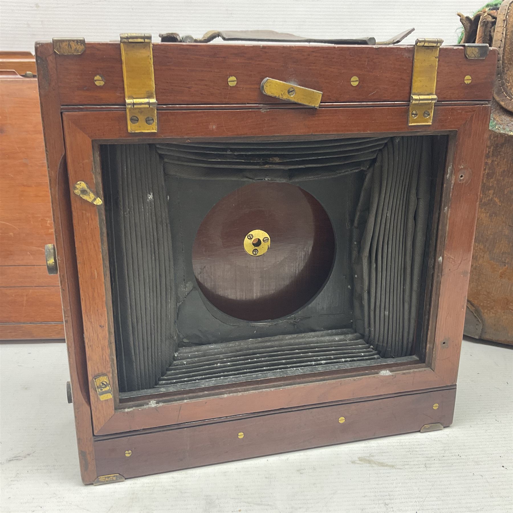 Collation of folding plate cameras of various sizes folding plate in mahogany and lacquered brass, together with camera plates and slides
By vendors repute some slide are from the Gandolfi workshop