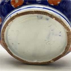 Pair of large 19th century Japanese Imari porcelain bottle vases, painted with shaped reserves of peonies, chrysanthemums and prunus blossom, each H46cm