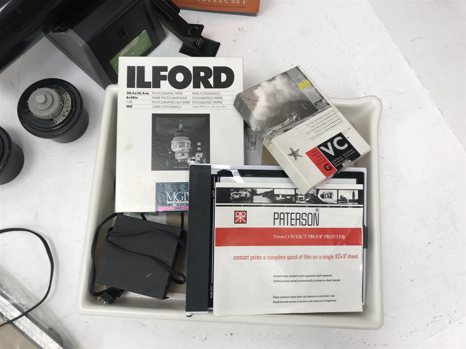 Large quantity of photo developing, dark room and photography equipment - quantity of Fogro 2'' x 2'' slide frames, PHILIPS movielight PSG125, Paterson 2 print forceps, atlas photo flash M3 clear, two Paterson 35mm developing tanks, Ilford photography paper 12'' x 16''and 8'' x 10'', Fujifilm photography paper 8'' x 10'' and 12'' x 16'', Rondinax 35U developing tank boxed, Simma Roller, two Ilford processing drums 30x40cm and 20x25cm, two other processing drums, Paterson 35mm contact proof printer, S&K 60D-C colour analyser etc... in three boxes