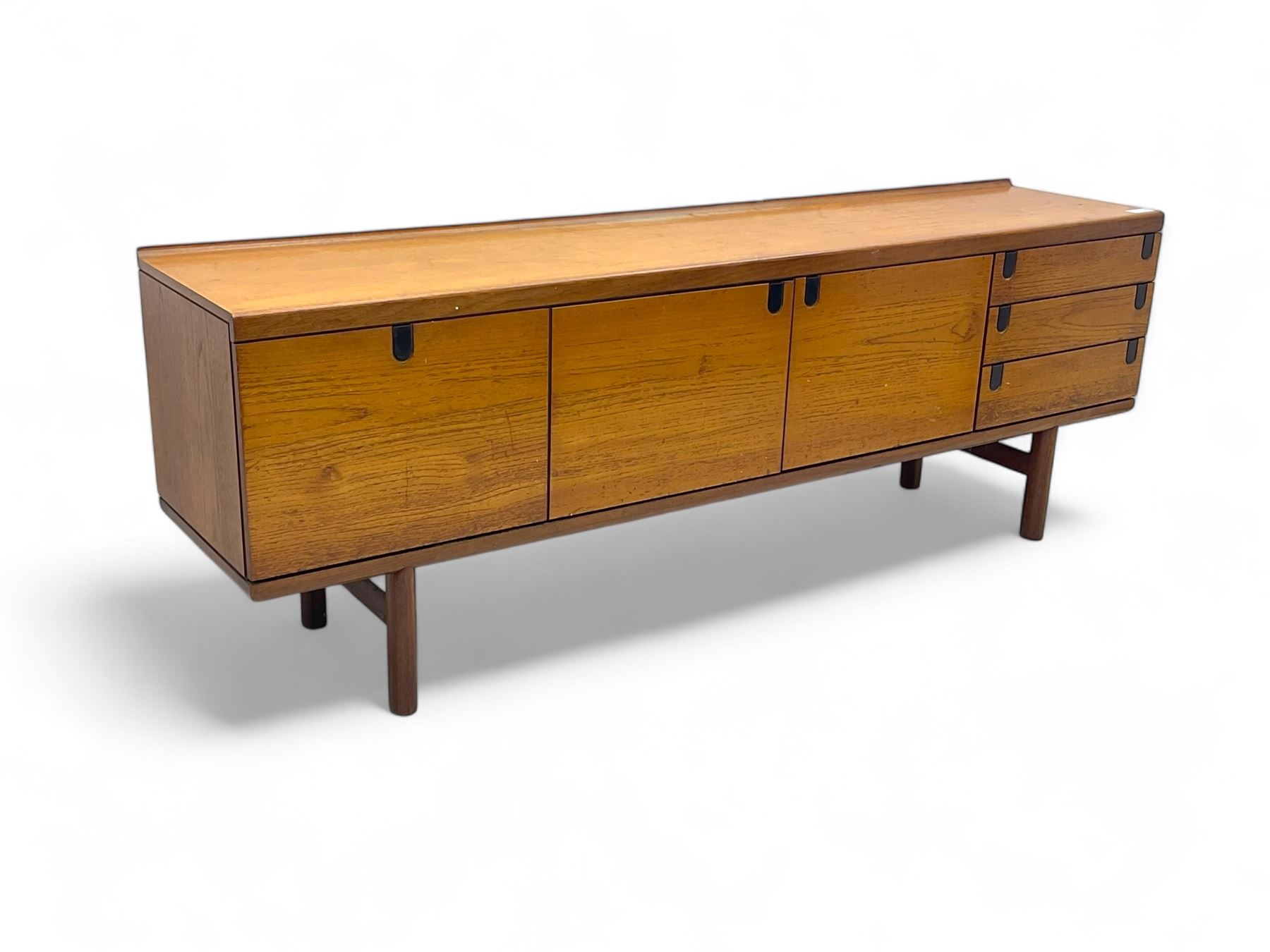 White & Newton - mid-20th century teak sideboard, rectangular top with raised back over fall-front storage compartment, double cupboard and three drawers, raised on cylindrical supports