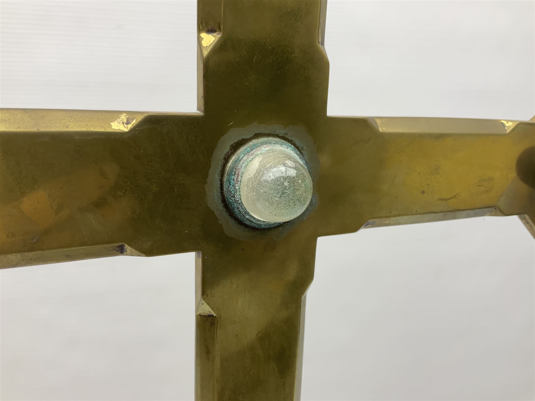 Brass alter cross, decorated with glass cabochons, upon a acicular stepped base and three claw feet, H73cm 