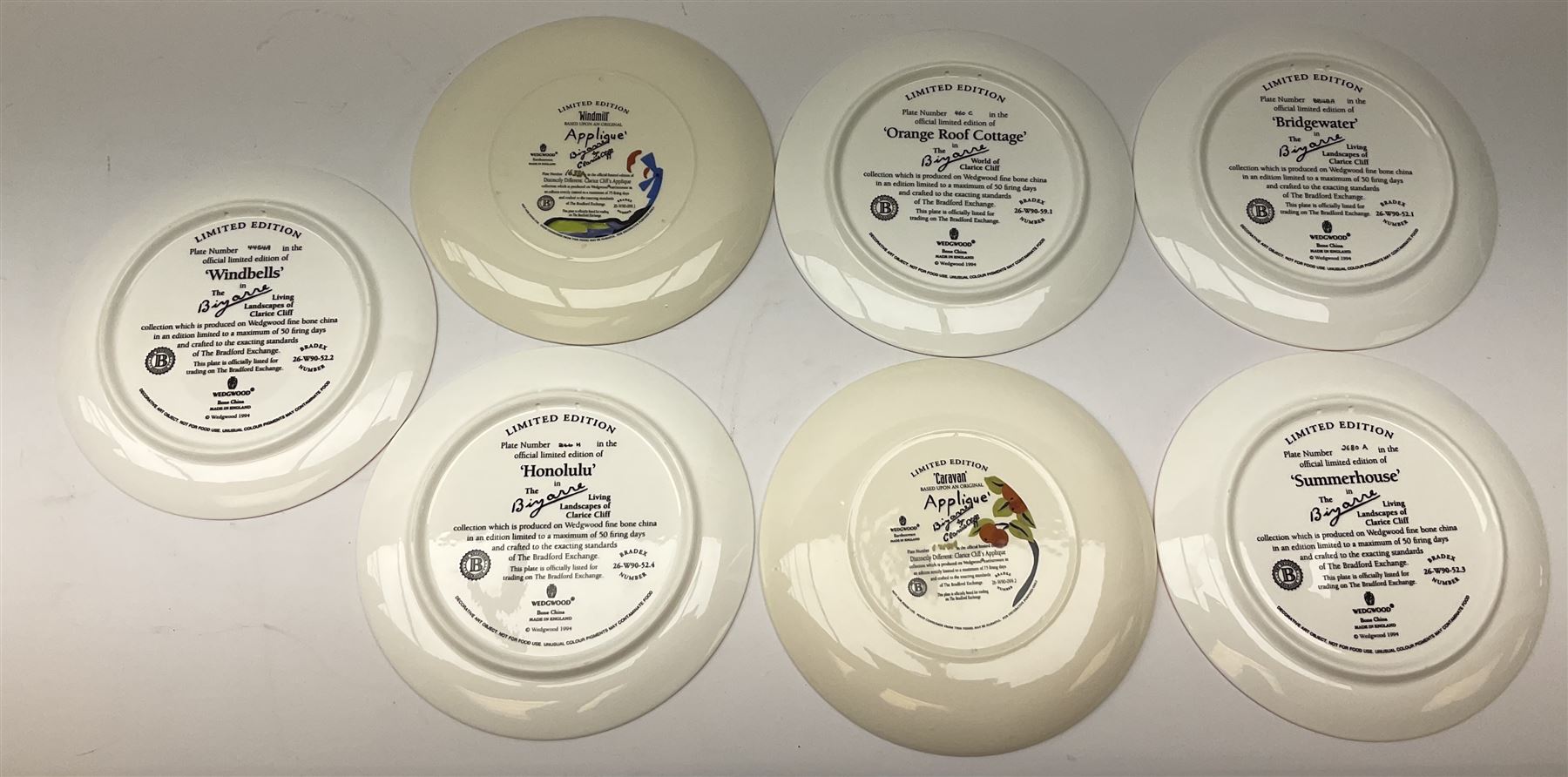 Seven limited edition Wedgwood Clarice Cliff plates, comprising Orange Roof Cottage, Caravan, Windmill, Windbells, Summerhouse, Honolulu and Bridgewater D20.5cm. 
