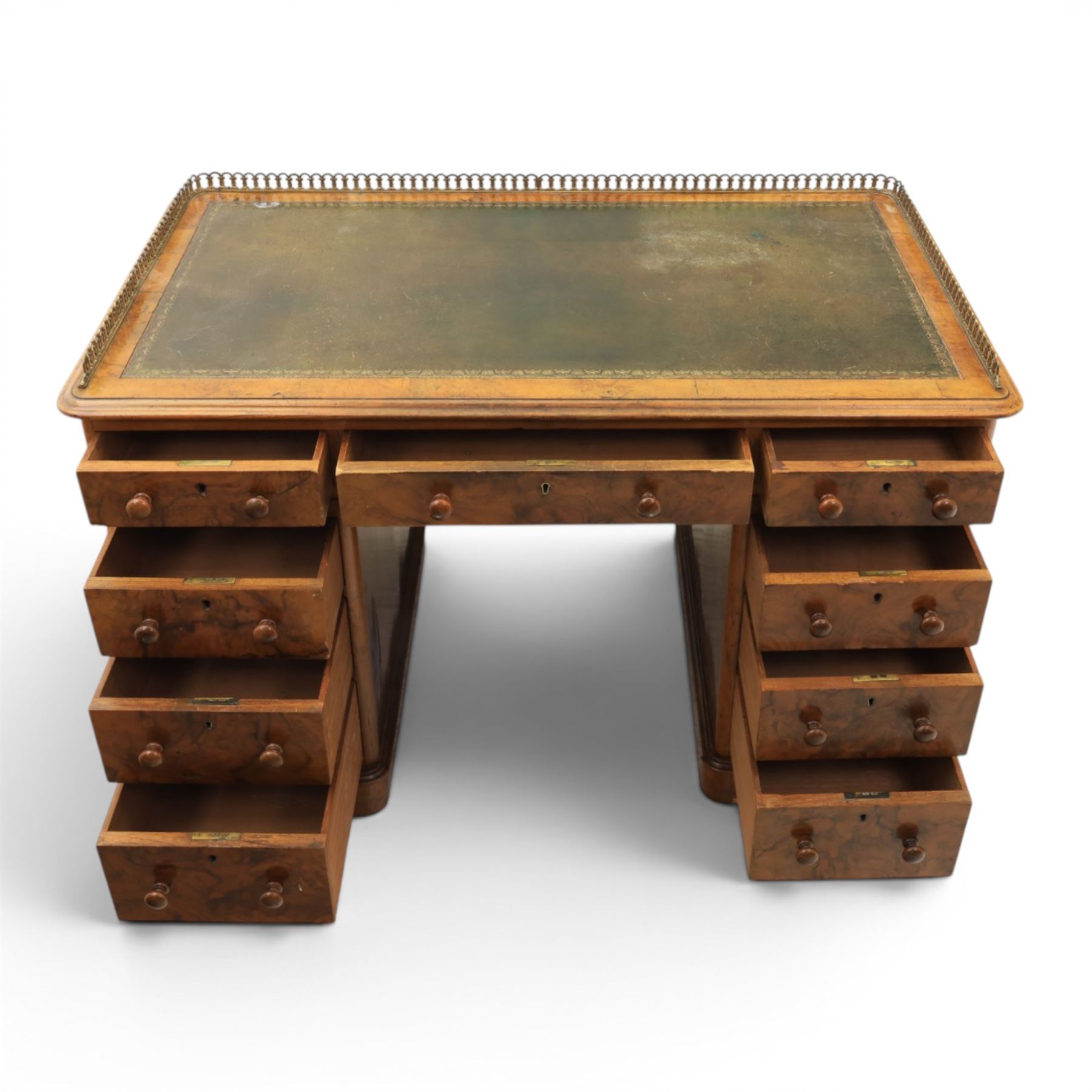 Victorian figured walnut twin pedestal desk, brass galleried top with inset tooled green leather writing surface, above three frieze drawers, raised on two pedestals with three drawers, on plinth bases above castors