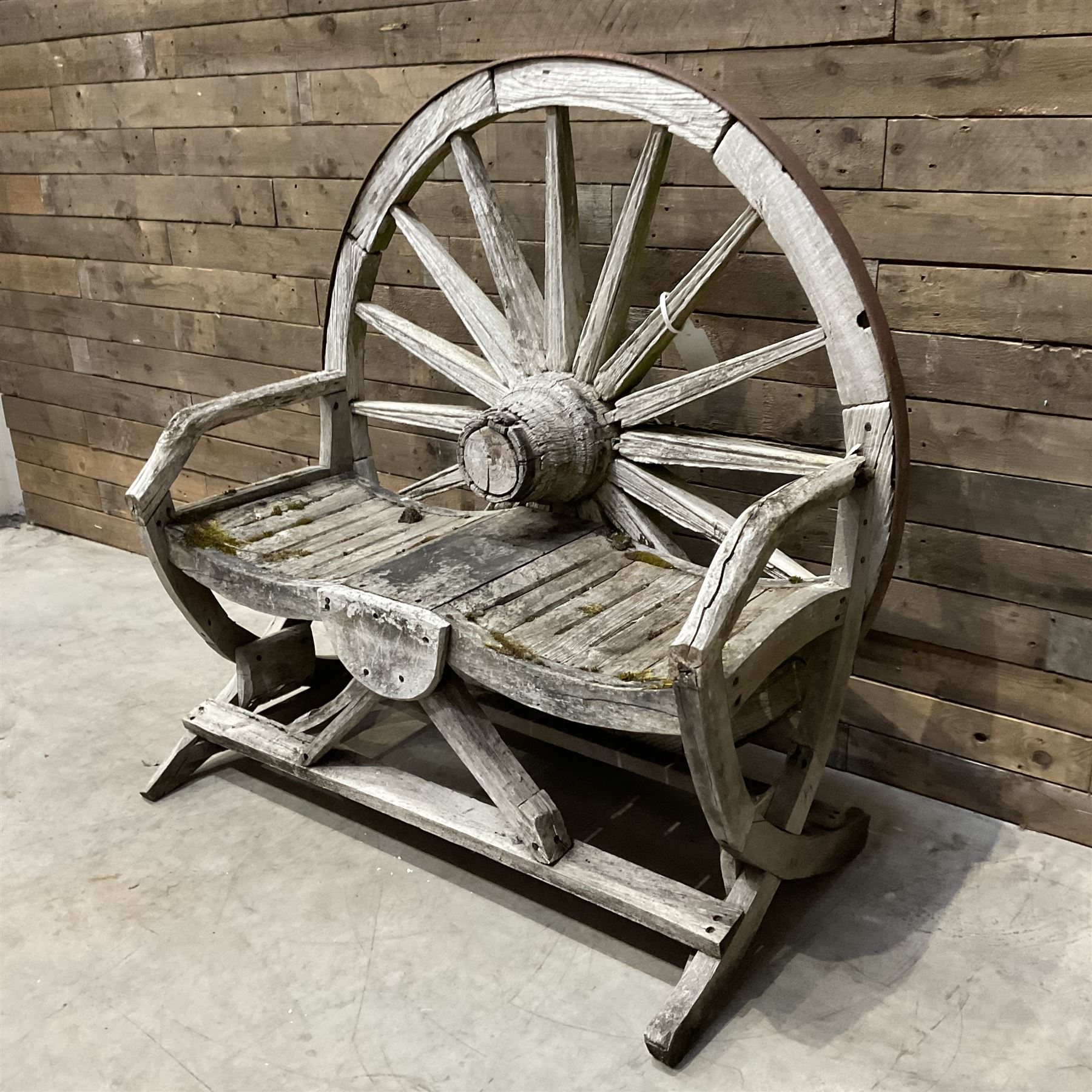 Early 20th century timber framed cartwheel garden bench