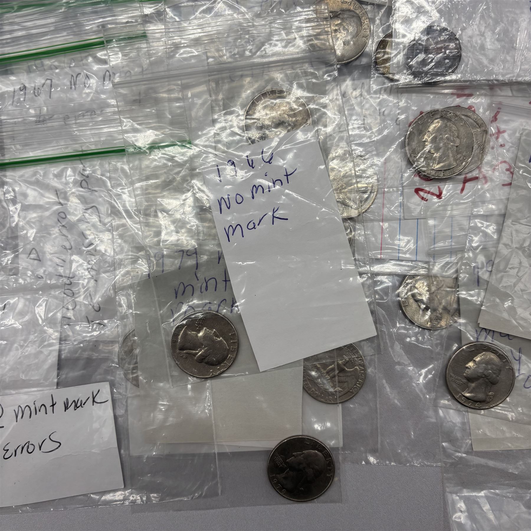 Collection of United States of America coins, 1965 onwards, principally quarter dollars, many with alleged minting errors as annotated on labels