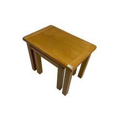Light oak nest of two tables, rectangular top raised on square supports