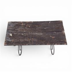 Cast iron garden table, with rectangular weathered slatted wooden top, raised on iron strapwork supports of scrolling form, in black painted antique finish 