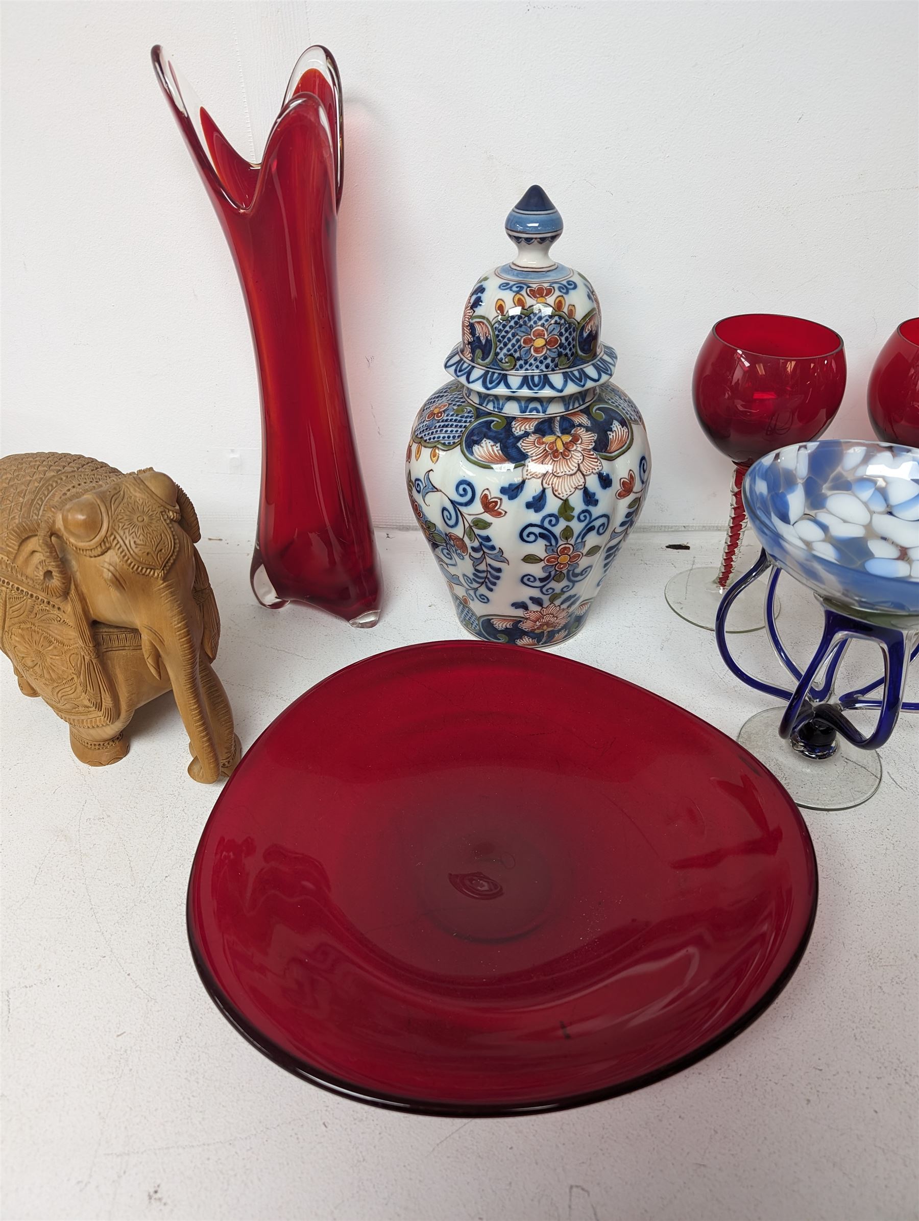 Makkum urn, collection of red art glass including large bowl and a carved wooden elephant, etc