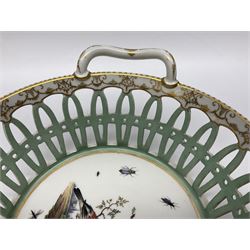 Pair of 19th century German openwork chestnut baskets, with twin handles and scrolling gilt border and star rim, painted to the centre with birds and insects, D22cm 