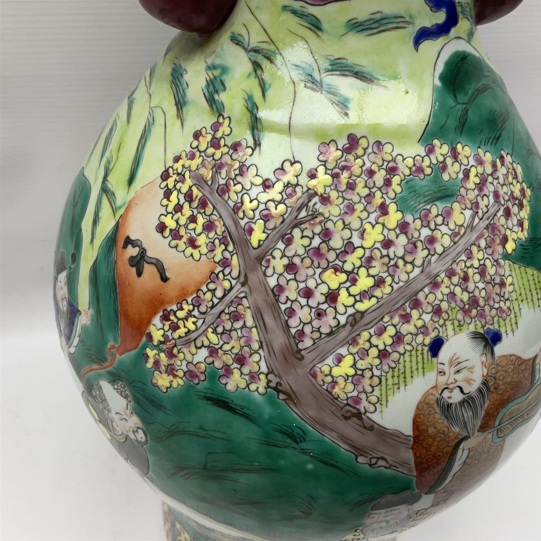 20th century Chinese Famille Rose vase, of baluster form with flared lobed rim and twin figural handles, decorated in polychrome enamel with figures dancing and playing instruments within a garden setting, H42cm