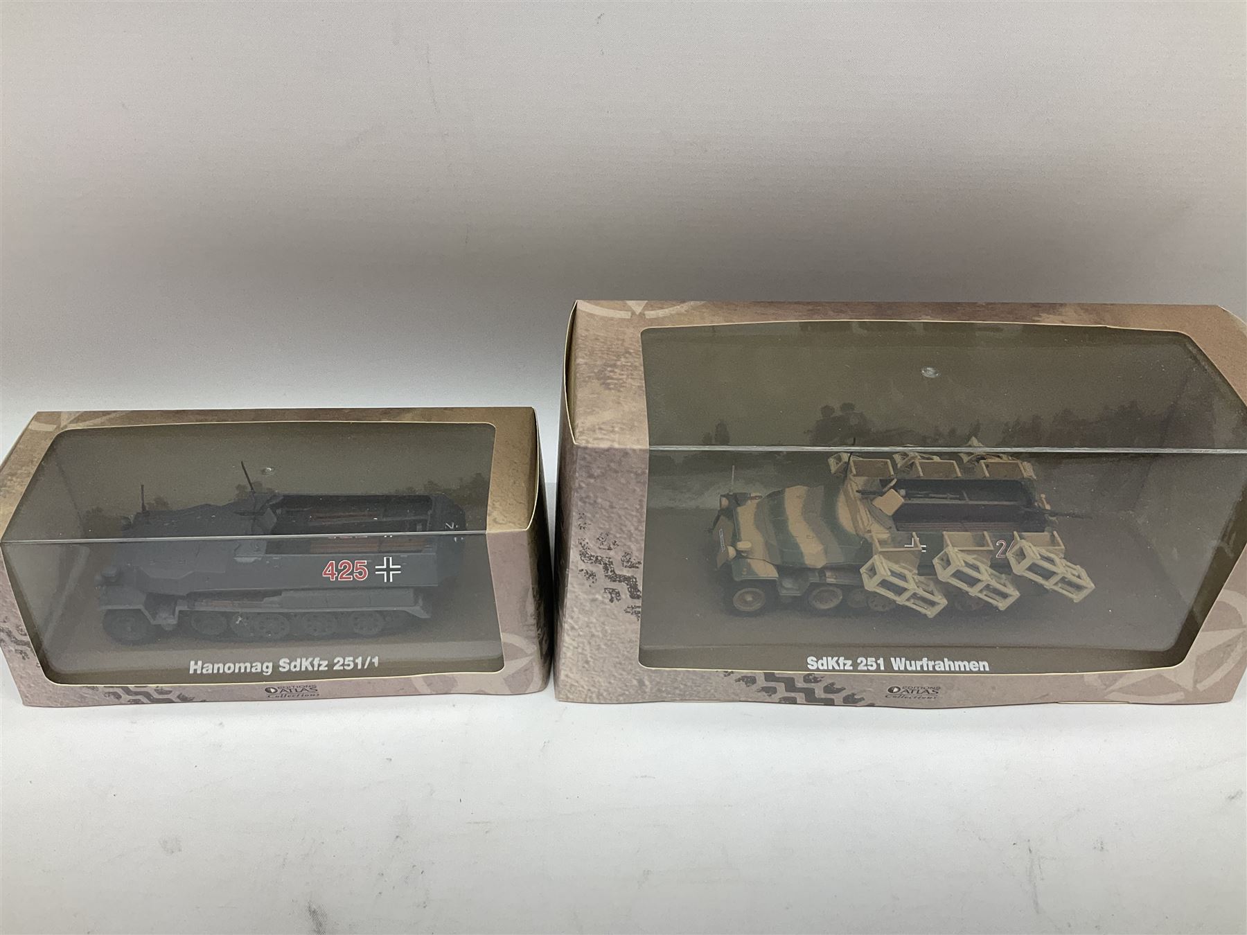 Sixteen Atlas Editions die-cast models of military vehicles including six Ultimate Tank Collection; all in perspex display cases; fourteen boxed; with associated paperwork (16)