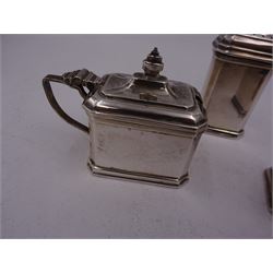 Mid 20th century silver three piece cruet set, comprising pepper shaker, open salt and mustard pot and cover, each of rectangular form with canted corners, hallmarked Adie Brothers, Birmingham 1954, the mustard pot and open salt with blue glass liners, together with a matched silver mustard spoon, hallmarked 