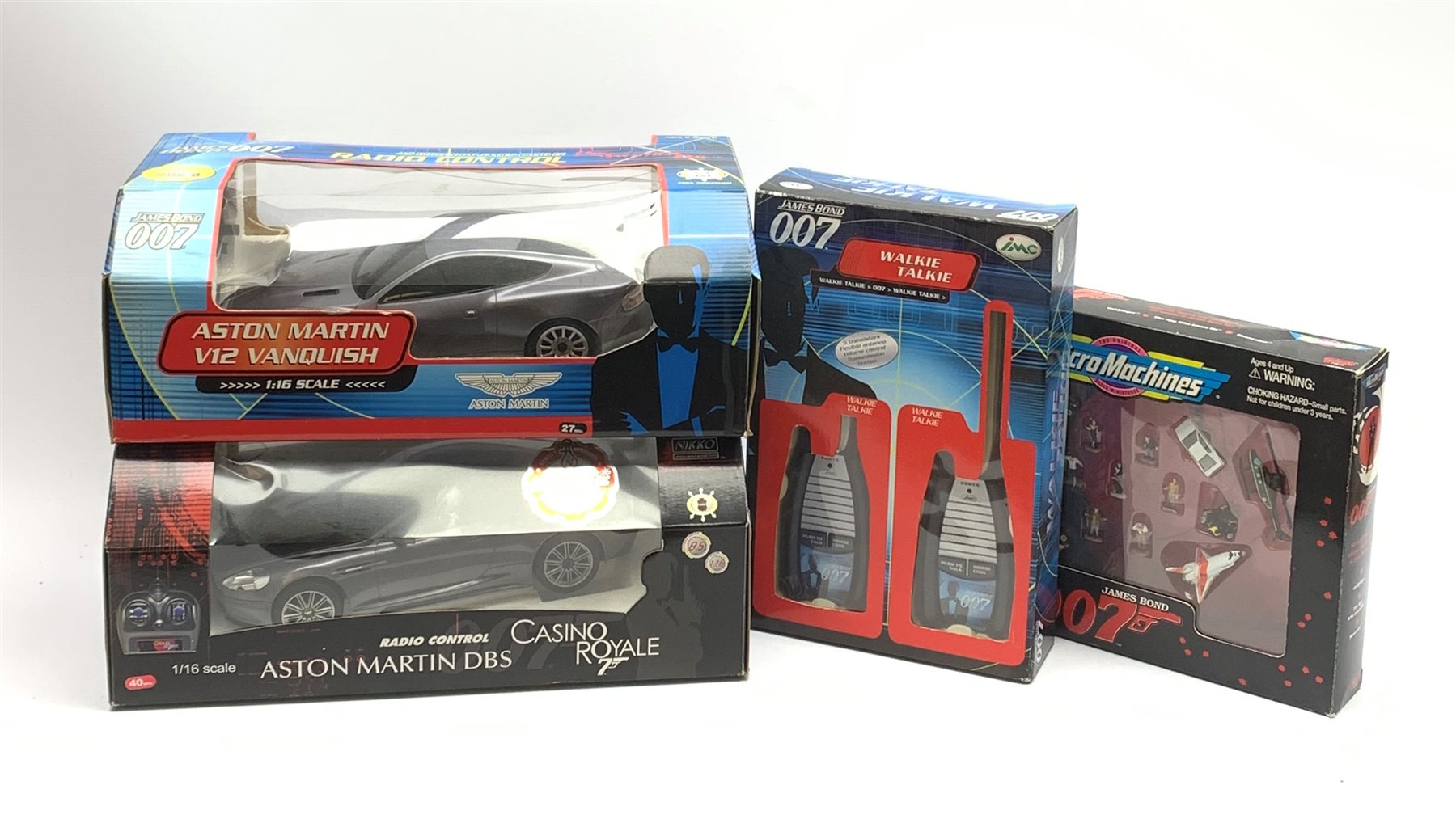 Two Nikko 1:16th scale James Bond radio controlled die-cast model cars - Aston Martin from Casino Royale and Aston Martin V12 Vanquish from Die Another Day; IMC 007 Walkie-Talkie Set; and Galoob MicroMachines 007 set with vehicles from Goldfinger, Moonraker, The Spy Who Loved Me, all boxed (4)