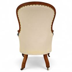 Fine pair of mid-19th-century mahogany library armchairs, carved frame with balloon-shaped back with scrolled ends, rolled wide arms, ending in a scrolled volute above a serpentine seat rail, upholstered in mottled turquoise faux leather, button upholstered back, arms, and cushion seat, studded sides and apron, raised on scroll carved front feet and splayed rear legs on castors 