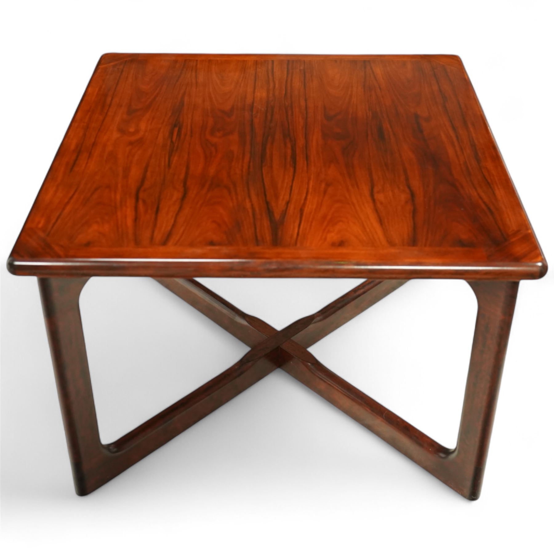 Dyrlund - contemporary Santos rosewood coffee table, floating design, square top of elegant design with clean lines and chamfered square legs 

Note: Dyrlund is a Danish furniture manufacturer known for its high-quality, handcrafted pieces, particularly in the mid-century modern style. Founded in 1960 by Frits Hjerte Dyrlund in Rude, Denmark, the company has remained a family business, now run by the second and third generations. Dyrlund specializes in both home and executive office furniture, focusing on practicality, solid construction, and classic design