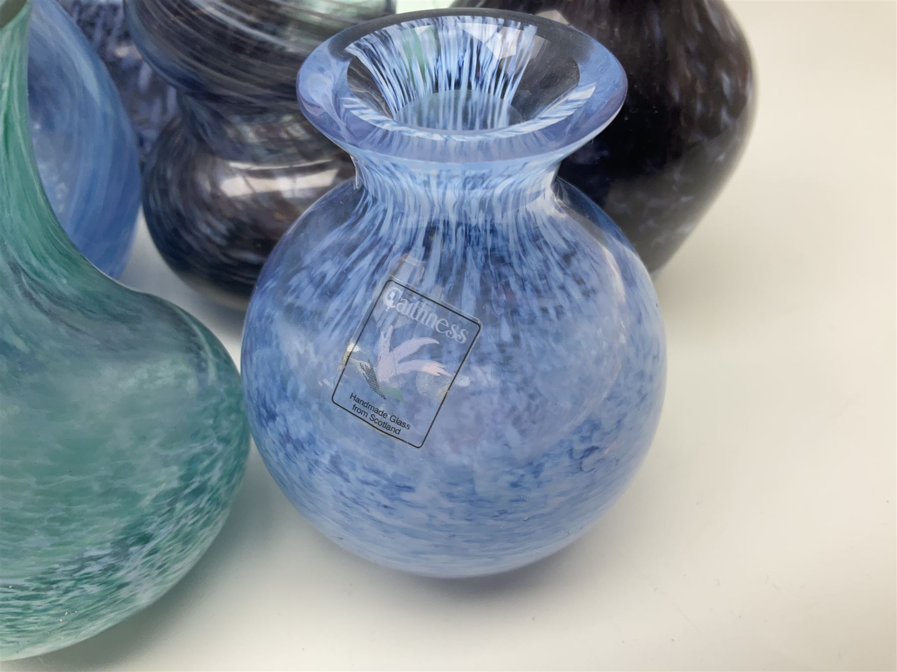 Collection of green/blue Caithness glass vases, to include mottled and swirl designs, largest 20cm (26)
