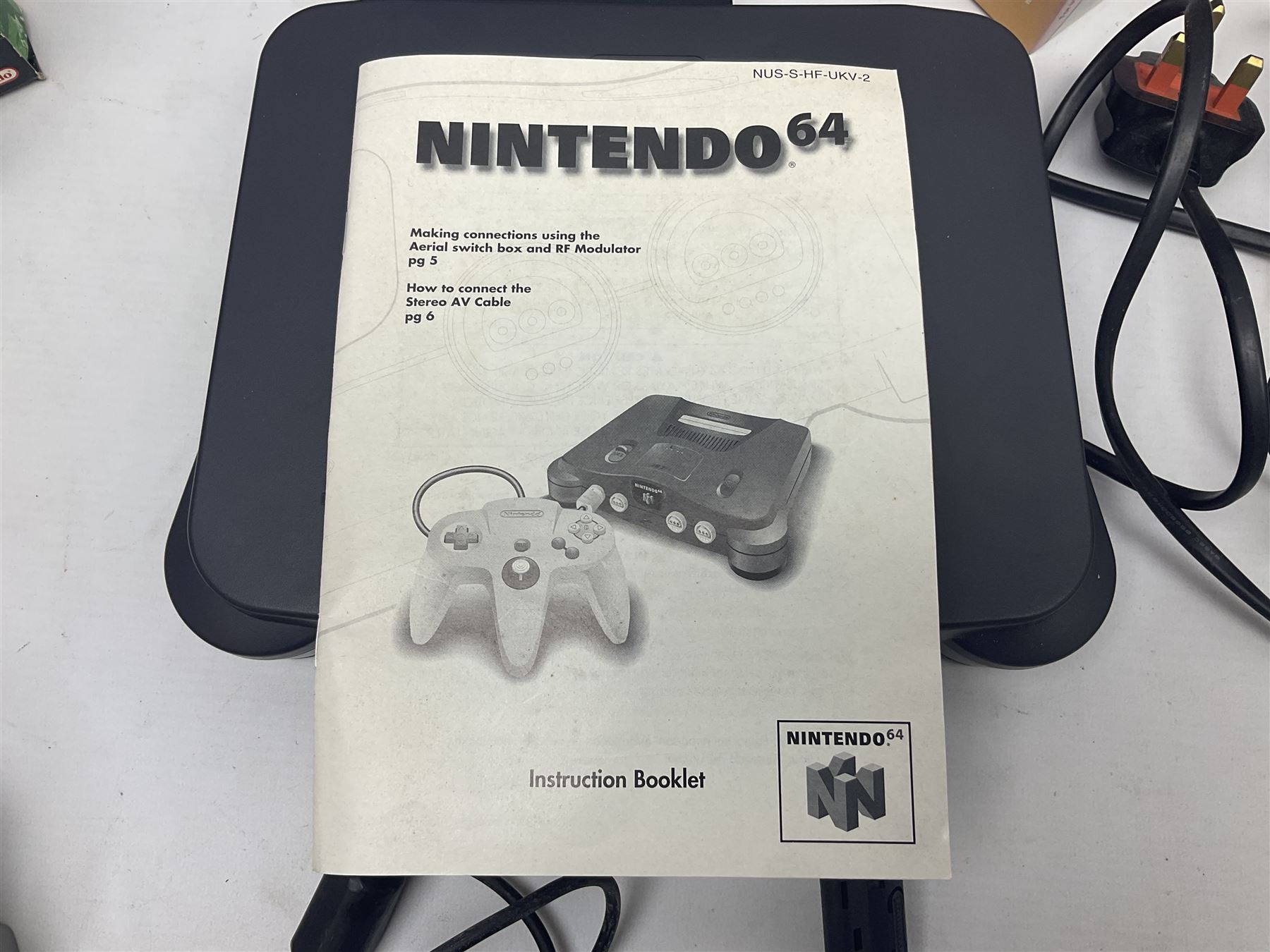 Nintendo 64 console, two controllers, games and accessories. Accessories to include the ‘Tremorpak’ and ‘Spook’ 2 Phono plugs and a S-VHS plug with adapter, both in original boxes. Games to include ‘Golden Eye 007’, ‘Doom 64’, ‘Killer Instinct Gold’, ‘Tetrisphere’, ‘F-1 World Grand Prix’, ‘Pilotwings 64’ and ‘Lylatwars’ with ‘Rumble Pak’, all with original boxes and instruction manuals. ‘Star Wars Episode I Racer’ game cartridge in Shadows of the Empire box. 