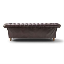 Thomas Lloyd - traditional shape Chesterfield two seater settee with rolled back and arms, upholstered in buttoned deep oxblood leather with loose seat cushions, raised on turned feet