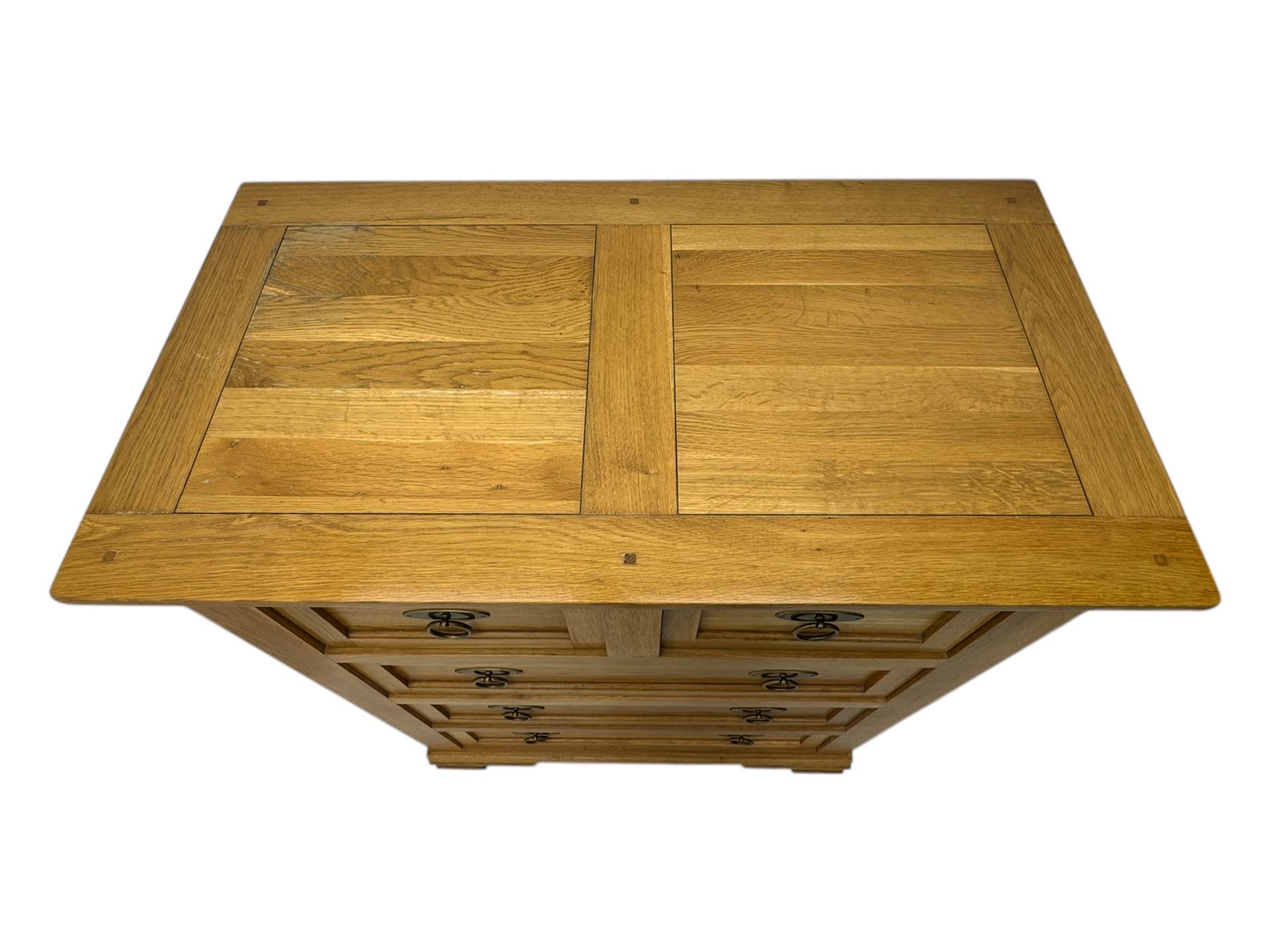 Frank Hudson - contemporary light oak chest, rectangular moulded top over two short and three long drawers, brass oval backplates with circular drop handles, on a moulded plinth base with bracket feet