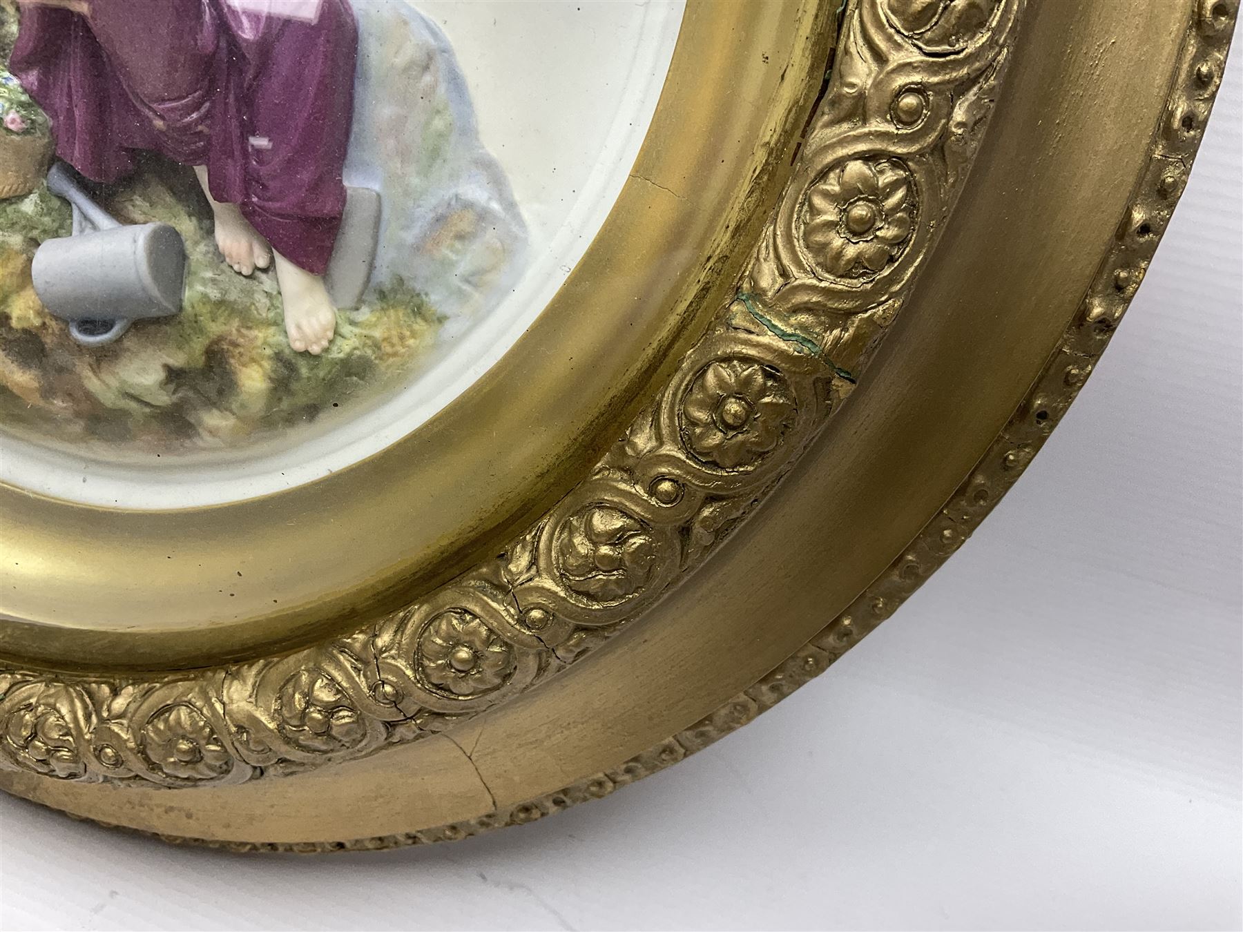 Set of four early 20th century Continental bisque plaques, each of circular form, modelled in high relief as the Four Seasons personified, within gilded circular frames under convex glass, overall D44.5cm