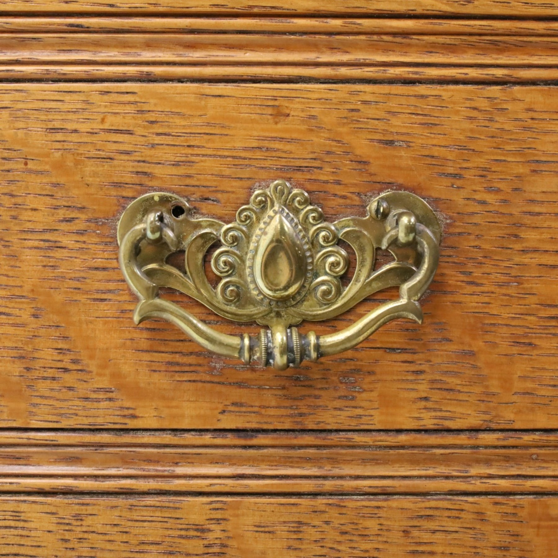 Maple & Co. - Arts & Crafts oak dresser with stained glass cupboard, raised section with pierced pediment above a mirrored back, with a stained glass fronted cupboard with fixed shelf, single long drawer, above a pair of fielded panels, with open recess above a short drawer, raised above a full length undertier with turned supports