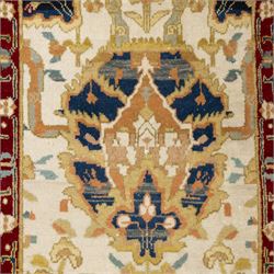 Agra wool runner, cream field decorated with large stylised palmettes, scrolling vines and flowerheads, enclosed by red main border with foliate motifs and fringed ends
