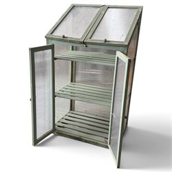Three green-painted timber cold-frame greenhouses or growhouses, each with twin hinged sloping polycarbonate lids above a pair of panelled doors enclosing slatted shelves