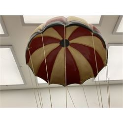 Painted wooden hanging model of a hot air balloon group, the balloon above a wicker basket complete with sandbags and figures, together with a similar example with a clown figure below, H68cm