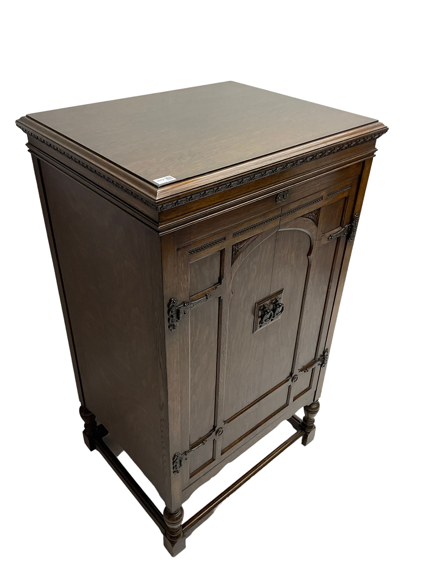 Early 20th century ‘HMV' 202 cabinet gramophone, oak cased, moulded top with foliate carved moulding hinges to reveal gramophone, two doors enclosing horn, on turned supports joined by moulded stretcher rails