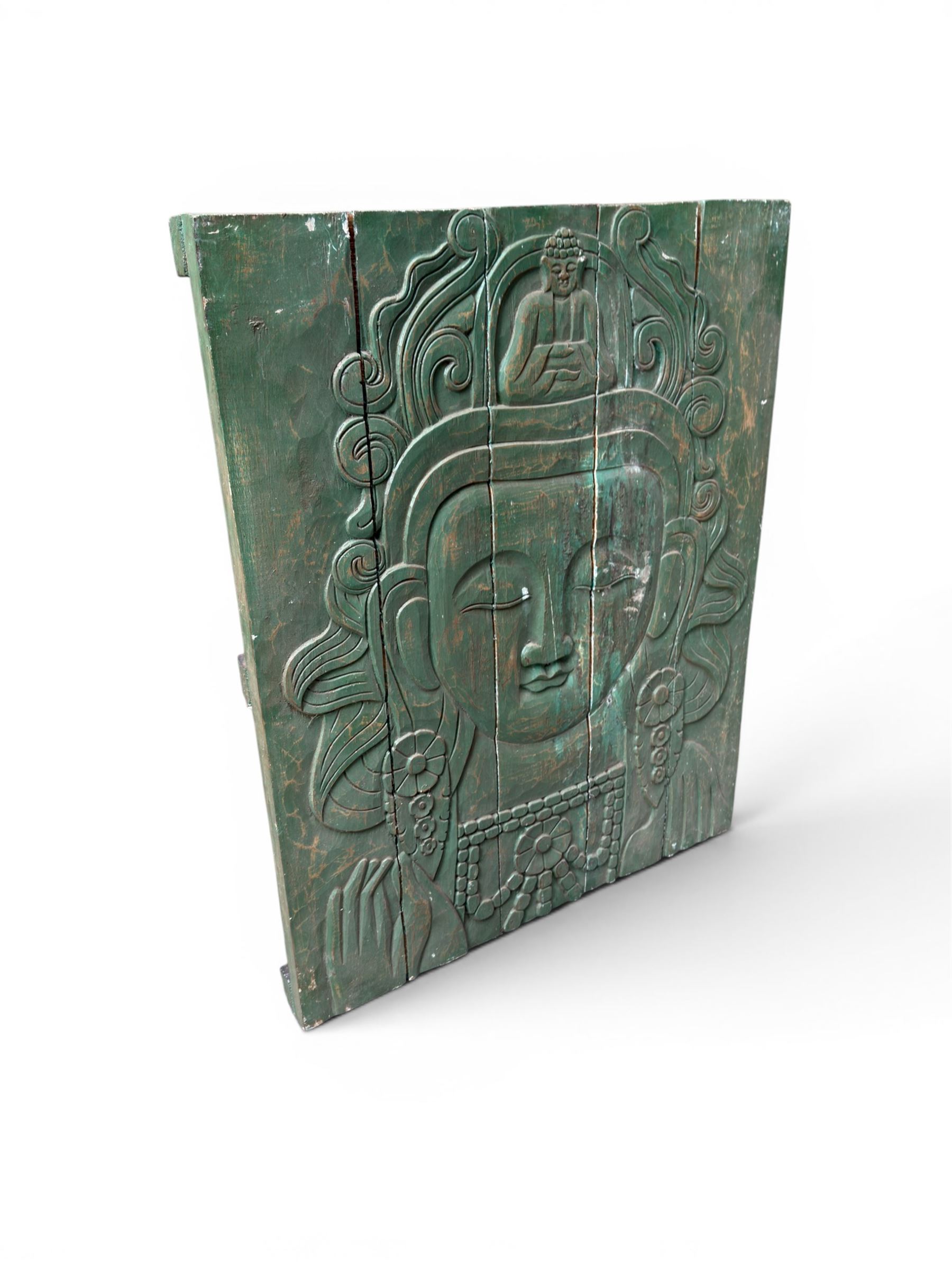 Pair of South East Asian carved wooden panels, depicting Buddha or Deity faces