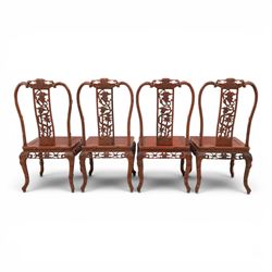 20th century Chinese ornately hardwood dining table and chairs, circular table with 'Lazy Susan' top with pierced carved frieze, raised on a quadriform base with carved foliate detail, the chairs en suite with carved pierced detailing  