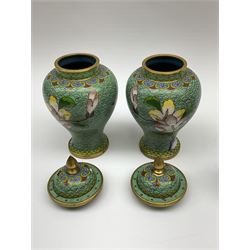 Group of cloisonné to include vase of ovoid form decorated with panels of exotic birds amongst flowers, beneath a foliate band upon a peach ground, two pairs of vases to include lidded examples and a miniature jug decorated with butterfly amongst foliage, tallest example H14.5cm