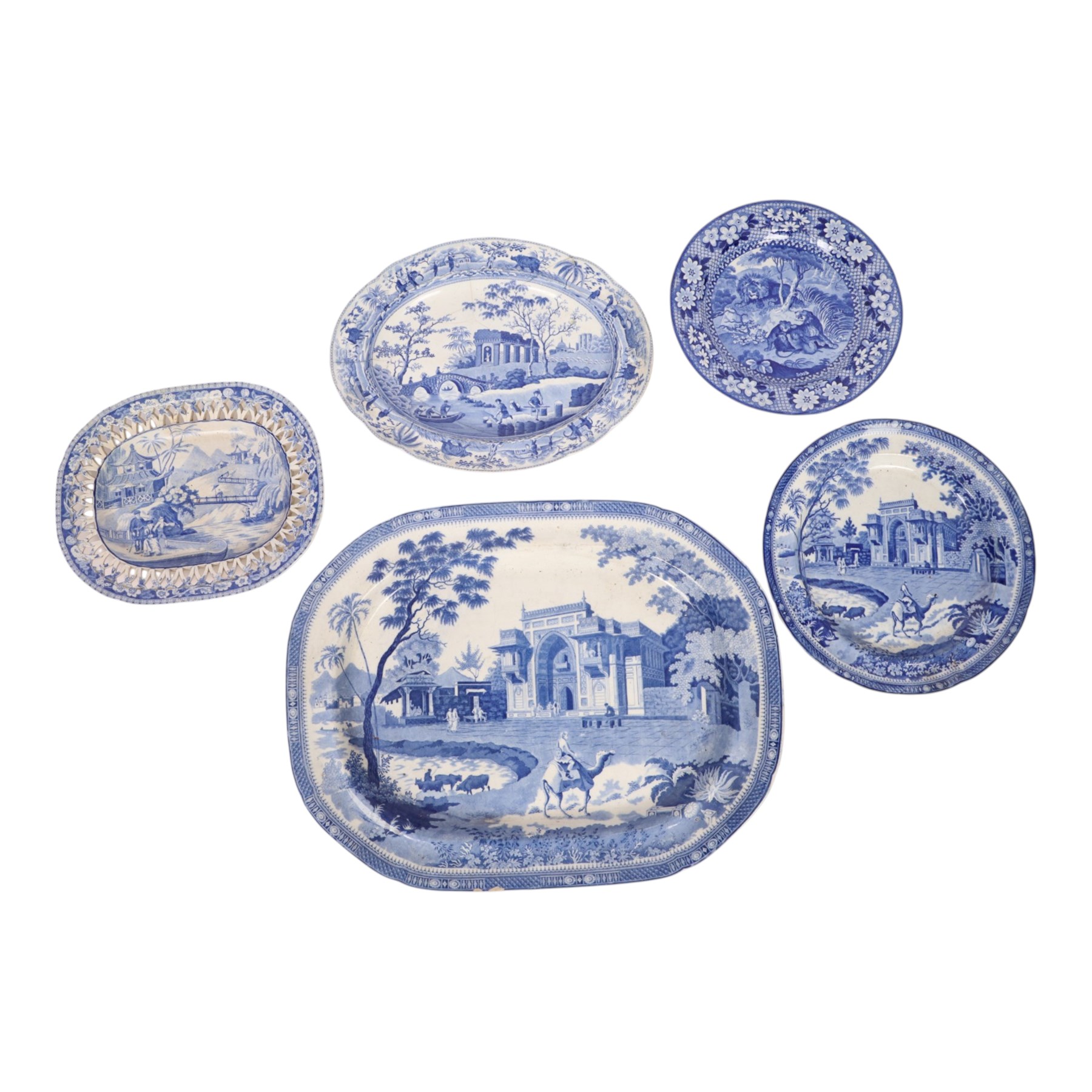 Early 19th Century Spode Caramanian series serving dish, printed in blue and white with the Triumphal Arch at Tripoli in Barbary, reserved within a running border of Indian sporting animals, together with Rogers Camel pattern platter and plate, Adams Lions plate and Davenport platter, largest platter L43cm 