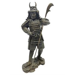 Bronze figure of a samurai standing wearing armour and holding a naginata, upon a rocky base, H48cm