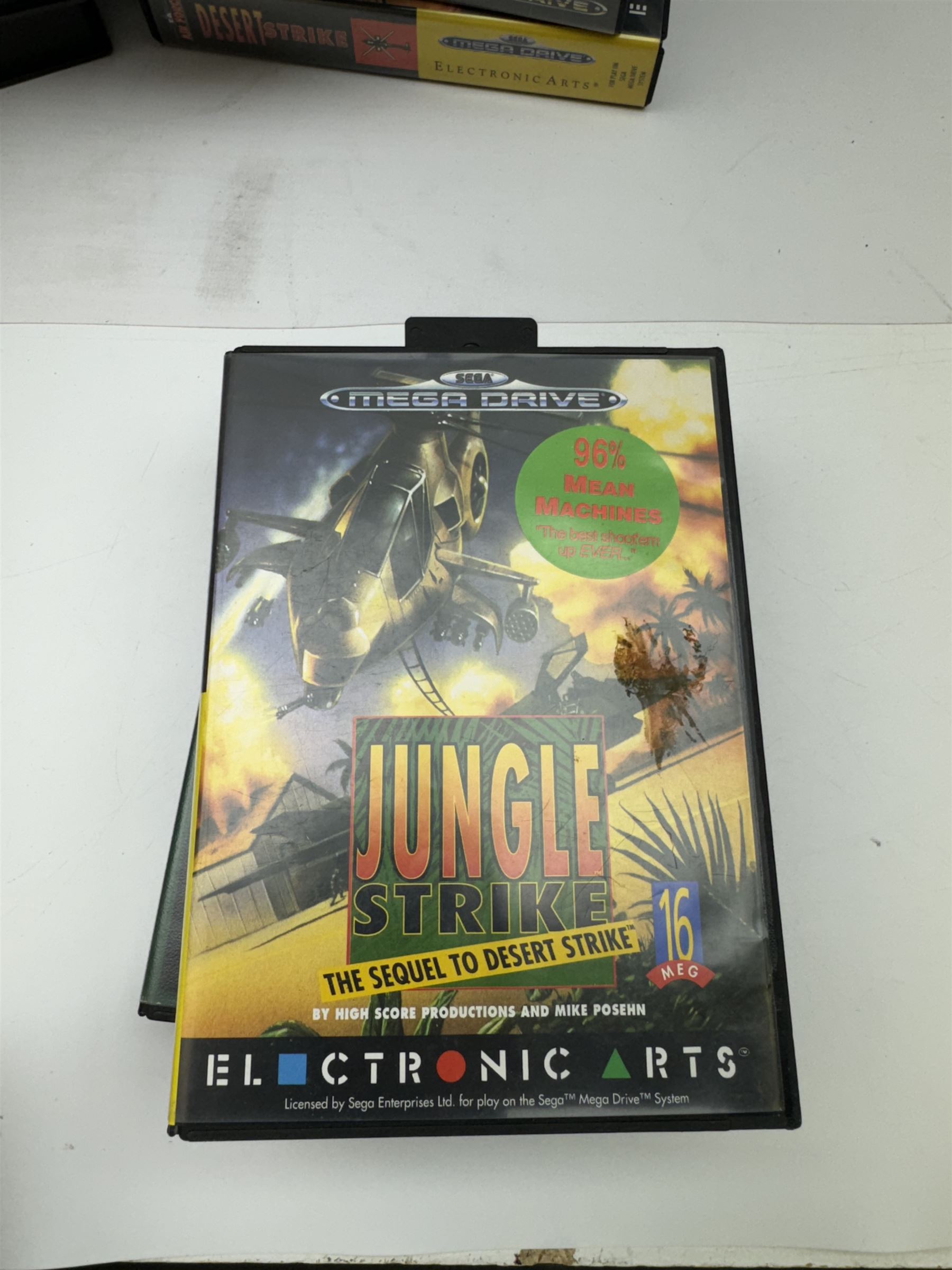 Eighteen Sega Mega Drive games, including Sonic The Hedgehog, Sonic The Hedgehog 2, Alienstorm, Desert Strike, Fatal Rewind, Road Rash etc, all boxed, together with a Sega Mega Drive controller, cartridge converter and an arcade power stick controller