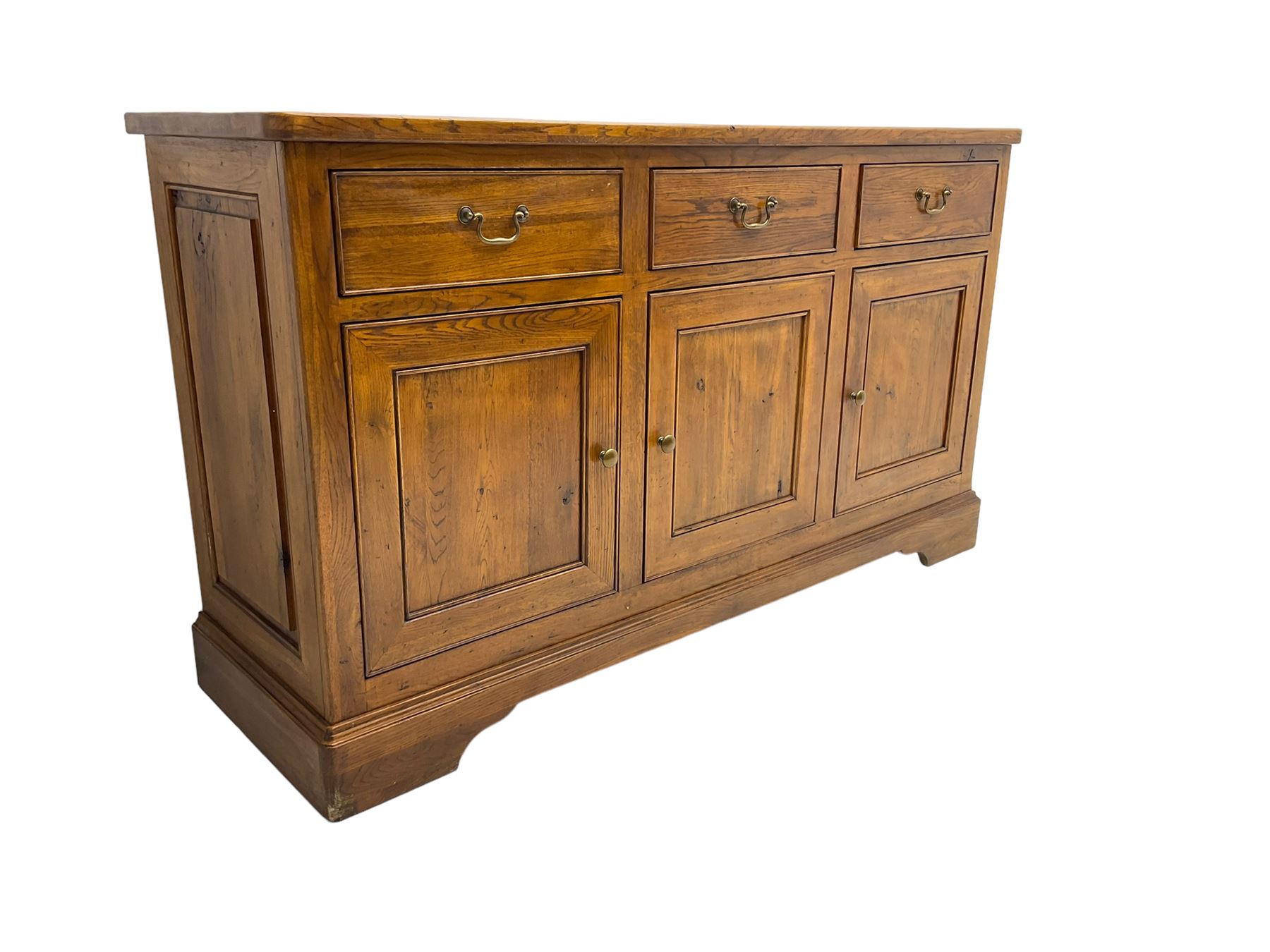 Willis & Gambier - oak sideboard, three drawers over three panelled cupboards, on bracket feet 