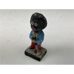 Robinson Jam plaster Golly band, including drummer and singer, H7.5cm

Originally handmade by mothers in Africa for their children from old fabric and cloth, the golly doll was adopted as the mascot and trademark for the Robertson's confectionery brand around 1910 after the company's founder John Robertson visited the US and noticed children playing with them. Robertson's Gollies have been collected by people across the UK and around the world for generations but garnered a contentious image in the 1980s because of links to racism. The trademark was removed from Robertson's branding in 2001.